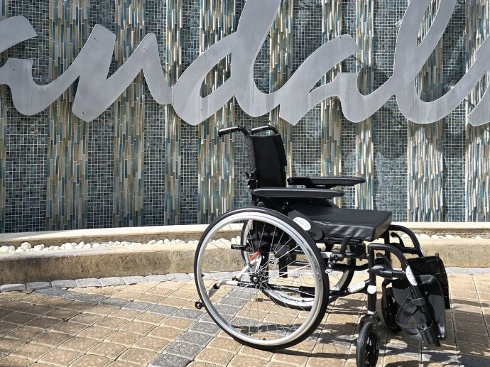 Wheelchair in front of Sandals resort sign